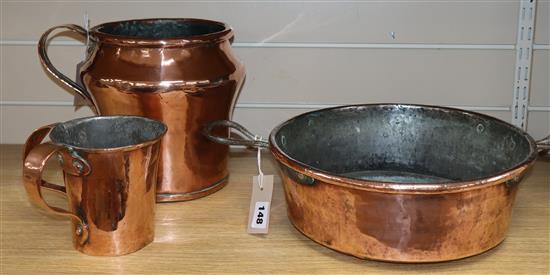 A copper preserve pan, a large copper jug, a double-handed jug and two tankards tallest 23cm